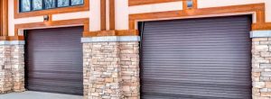 Blog 11 Garage Door service in Charleston SC Modern brown garage doors with stone and wood accents on a home exterior.
